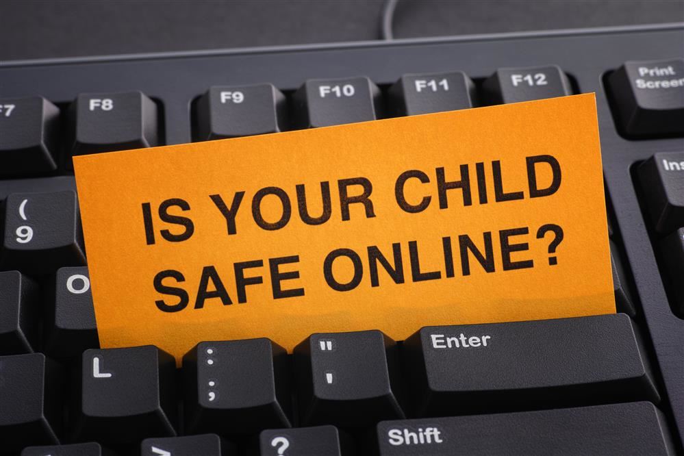  Is your child safe online card on a keyboard